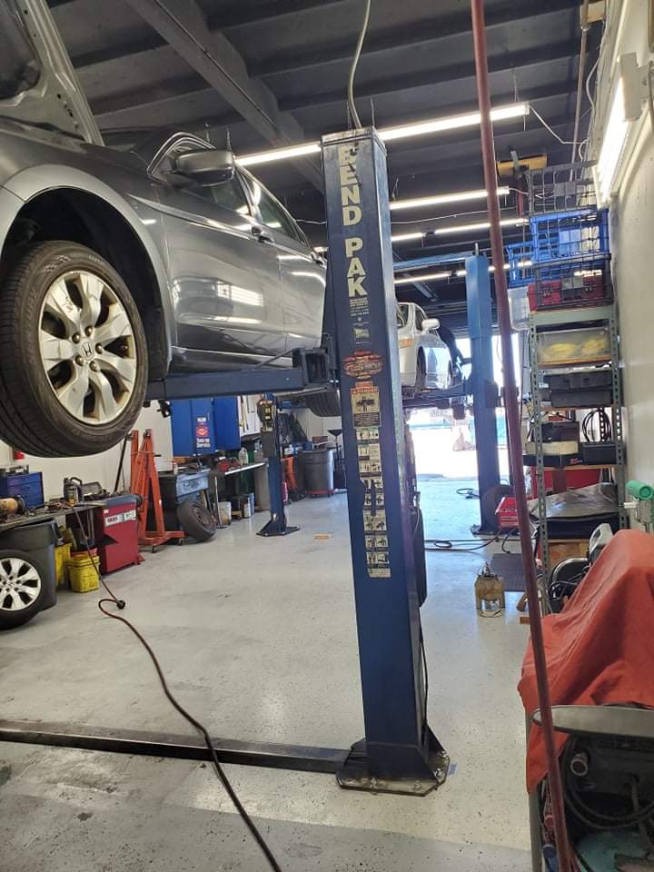 Honda on a two-post lift in the service bay